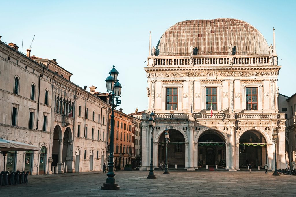 pexels-photo-29970176-29970176 Beautiful historic building in Italian plaza during sunrise with warm light.